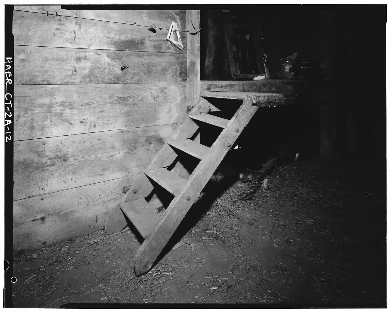 Short wooden stair in the barn interior. 