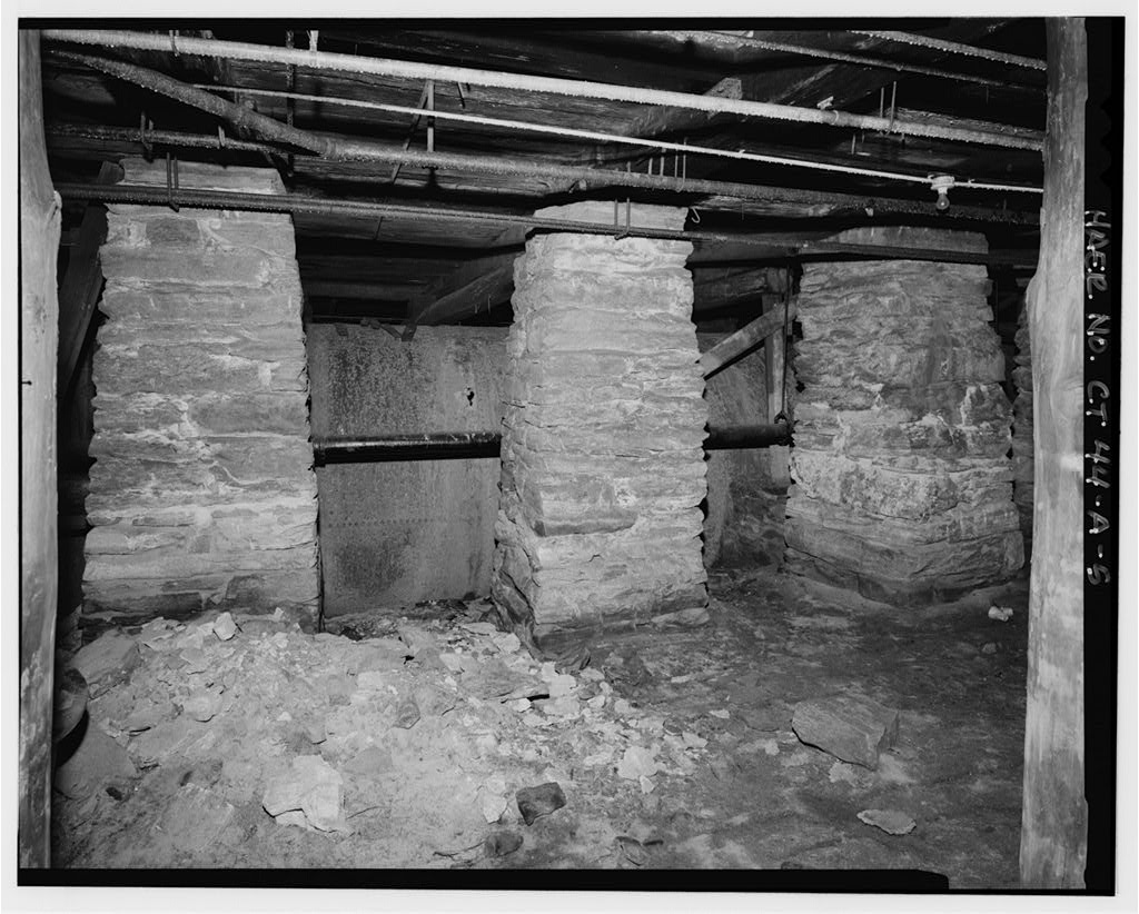 View west of penstock under mill