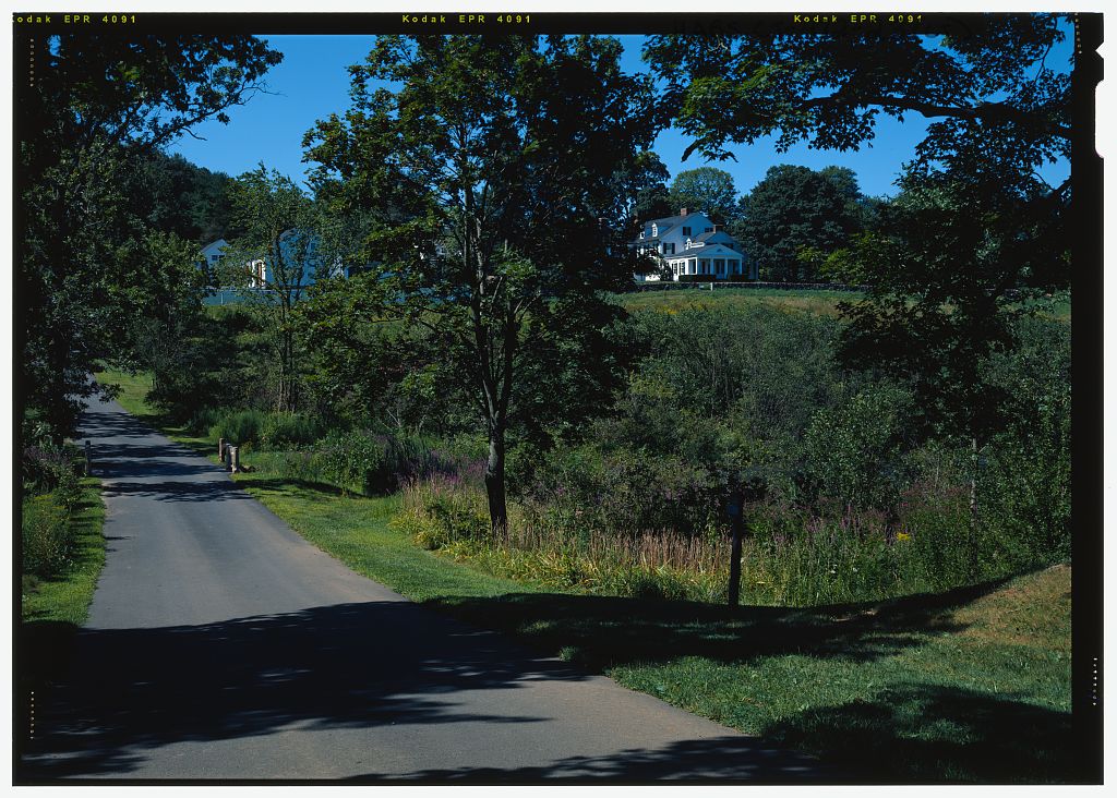 View from east/northeast of service road between farm and Pope-Riddle house complexes in color.  Note bridge at pond…