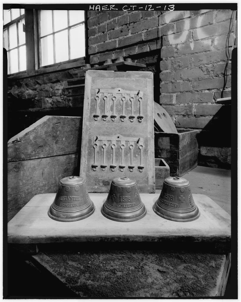 DETAIL VIEW OF HAND CAST BRASS BELLS AND KNOCKERS - Bevin Brothers Bell Shops, Bevin Court, East Hampton, Middlesex…