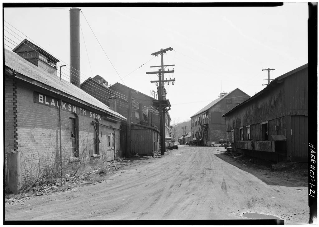 Blacksmith Shop, Compressor Room, Boiler Room, and Marine Railway Headhouse and Offices on left side of road;…